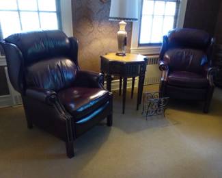 Pair of leather recliners, side table with faux books, lamp