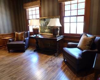 Pair of leather chairs, Library table, pair of lamps with lion's head trim, decorative art, decorative pillows