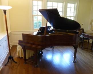 Antique baby grand player piano with music reels