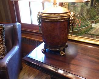 Pair of leather chairs, Library table, pair of lamps with lion's head trim, decorative art