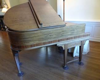 Antique baby grand player piano with music reels