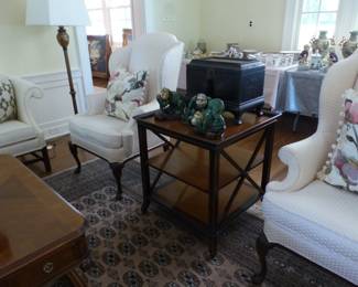 Pair of neutral wing chairs, decorative pillows mahogany 3 tier side table, bric-a-brac