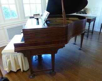 Antique baby grand player piano with music reels