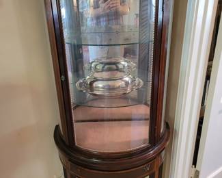Small curved glass curio cabinet