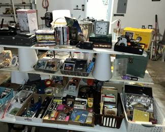 Table full of misc. from vintage cameras to cd's & DVD's.