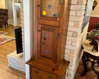 Warm, country pine clock cabinet filled with....