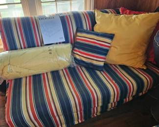Two futons. LYCKSELE brand. Includes striped cover, yellow mattress cover and striped throw pillow