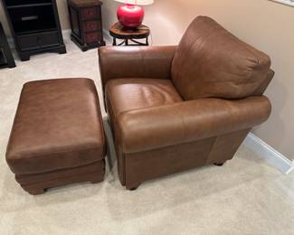 Brown leather cushioned roll armchair and ottoman by Ethan Allen