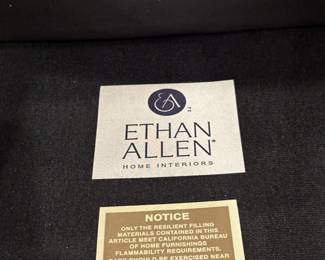 Brown leather cushioned roll armchair and ottoman by Ethan Allen