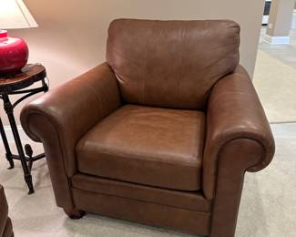 Brown leather cushioned roll armchair and ottoman by Ethan Allen