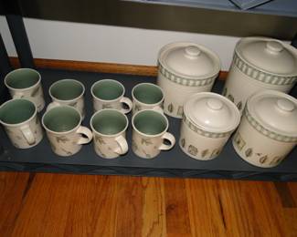 Coffee or tea mugs, and a matching canister set