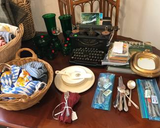 antique typewriter, silver plate flatware, linens, green glass, books