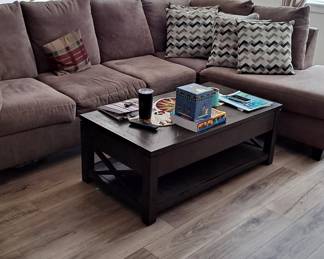 Large living room sectional sofa set; dark colored coffee table; decorator pillows