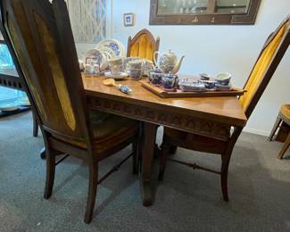 Spanish Baroque style dinning table with 6 chairs and extra table leaf. 