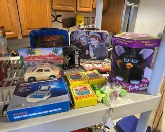 #60810 • (2) Lunchboxes, Refrigerator Magnets, Harley Davison Ceramic Mugs, Furby, and The Chevron Cars Toy
