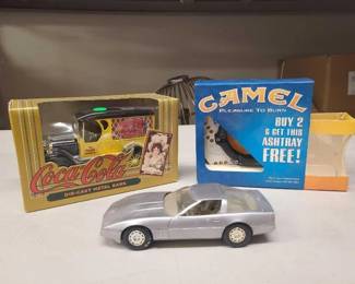 #1526 • Coca-Cola Die Cast Metal Bank, Model Corvette, and Camel Ashtray
