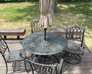 Wrought iron table and four chairs with umbrella.