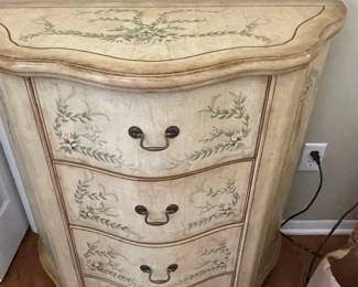 Decorative four-drawer chest of drawers.