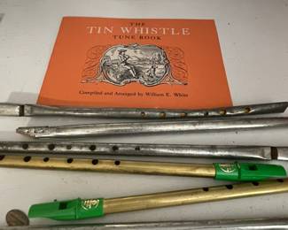Vintage tin whistles and book.