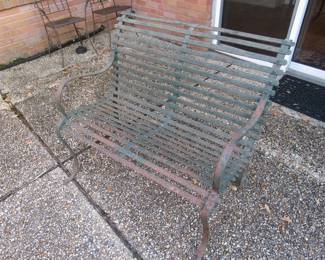 Antique iron bench with riveted construction