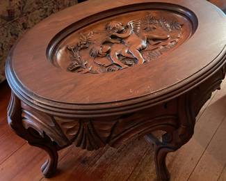 This is the same table without the tray in place so you can see the carving better.   Oval Victorian Style Table with carved Angel And Removable Glass Tray