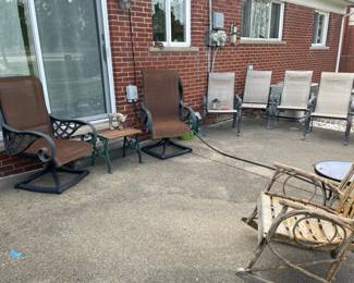 Sling back patio chairs, Side wood table, Tiger plant stand, Patio chairs, Hose and hose holder, watering cans, Pawley's Island hammock, Wood rocking chair, Glass and metal side tables