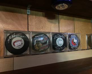 Signed hockey pucks