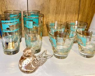 Close-up view of vintage glasses, bird paperweight