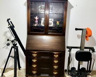 Bushnell telescope, drop front writing desk with glass doors and 4 drawer storage, exercise equipment