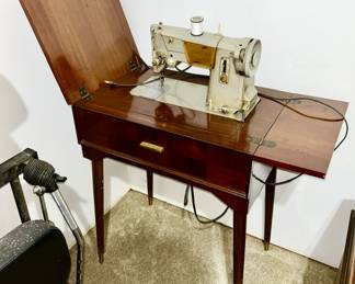 Singer sewing machine in cabinet