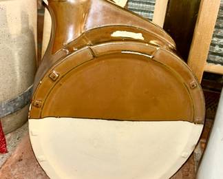 Side view of hourseshoe jug with broken handle