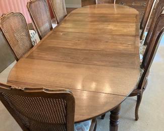 dining room table shown with 4 leaves (1 more)