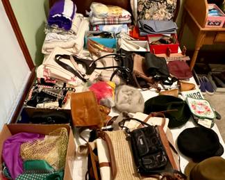 Full Size Bed Set covered in Blankets, Purses, Hats, Scarves, Sheets, and More