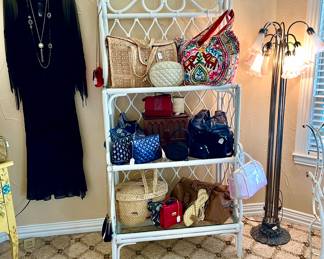 LOVE THIS RATTAN GLASS SHELF FULL OF HANDBAGS.