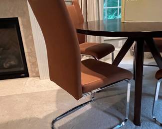 Set a four tan and chrome conference chairs