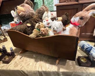 ANTIQUE CRADLE FULL OF STEIFF STUFFED ANIMALS