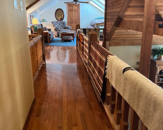 CROSS WALK TO UPSTAIRS ROOM...RAILING DISPLAY OF RUGS AND WEAVINGS