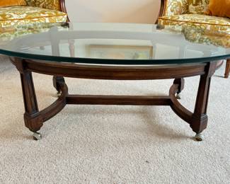 Vintage Oval Wood & Glass Top Cocktail Table On Casters. Measures 46.5" x 30" x 17" H. Photo 1 of 3.