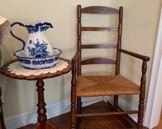 wooden rocking chair, piecrust accent table, blue and white bowl and pitcher 
