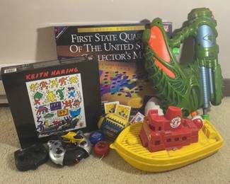Assortment Of Toys Including Remote Control Helicopter Quarter Map And Playing Cards