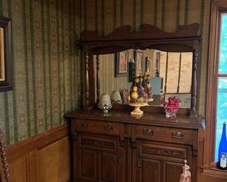Wooden sideboard with attached mirror, tabletop decor items