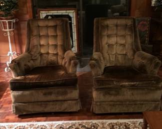 Matching gold velvet swivel chairs, large vintage area rug, plant stands