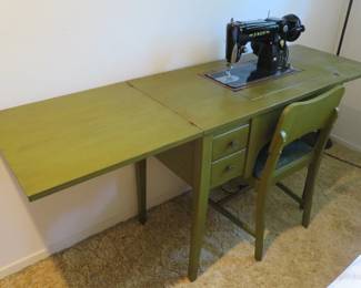 Singer 306W sewing machine with cabinet, chair, and accessories including discs. 