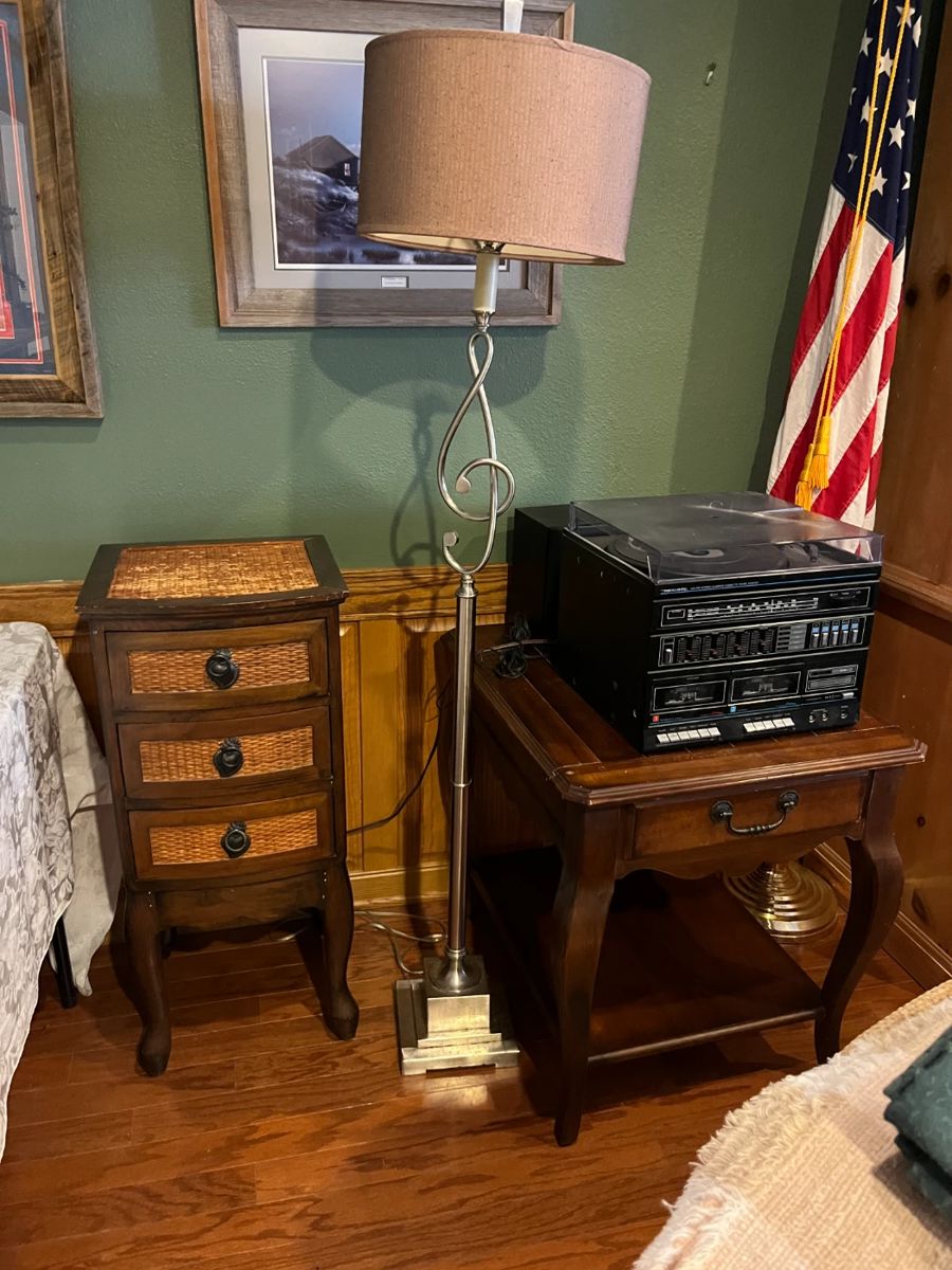 wicker and wood table, side table, stereo system, flag, framed artwork