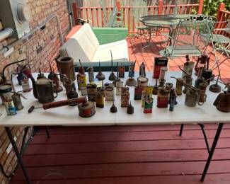 Vintage/Antique oil cans. Still dusty!! (Patio furniture shown is NOT for sale)