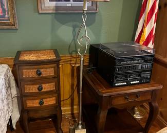wicker and wood table, side table, stereo system, flag, framed artwork