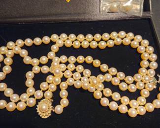 Double strand saltwater opera length pearl necklace with 14 karat and diamond clasp