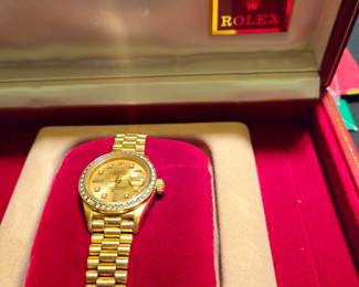 Ladies 18 carat gold with diamond bezel Rolex with inner and outer boxes, papers, wallet, and card holder - appears to be never worn.