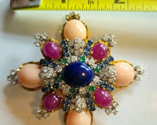 Retro brooch of angel skin coral, diamonds, cabachon rubies and center sapphire. Accented with sapphire and emerald stones. 14k. Large statement piece.