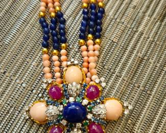 Have a jeweler add a bale and wear the brooch on this coral and lapis necklace